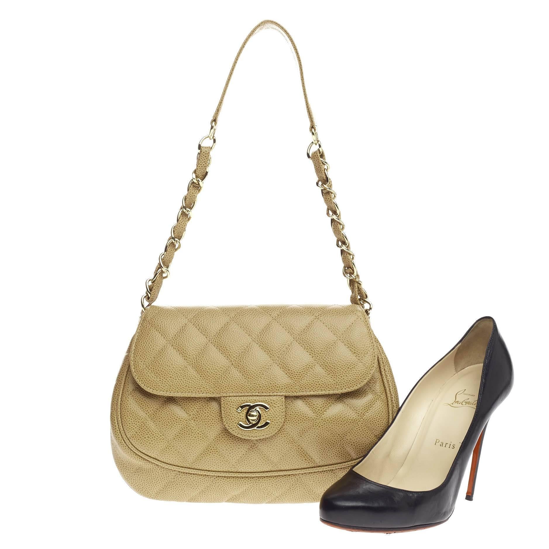 This authentic Chanel Vintage Round Classic Flap Quilted Caviar Medium is a timeless essential for any modern woman. Crafted from beautiful beige diamond quilted caviar leather, this coveted round classic flap features woven-in leather chain strap