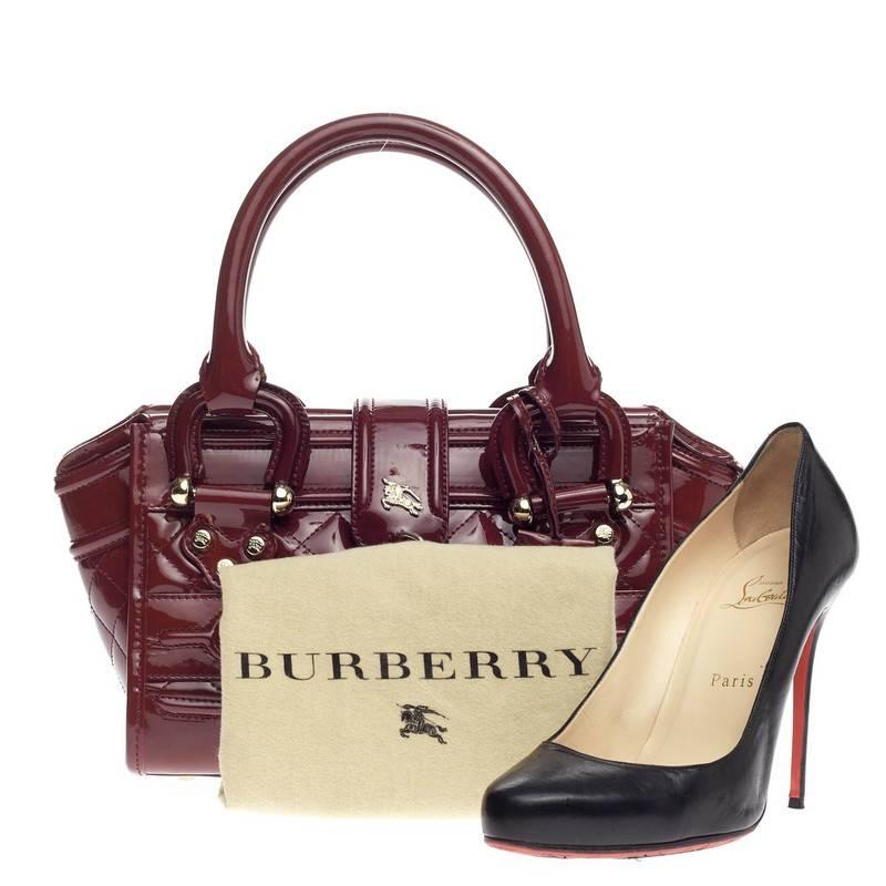 This authentic Burberry Manor Bag Quilted Patent Mini is sophisticated in style perfect for everyday casual look. Crafted from red quilted patent leather, this petite bag features dual-rolled leather handles, exterior front zip pocket, expandable