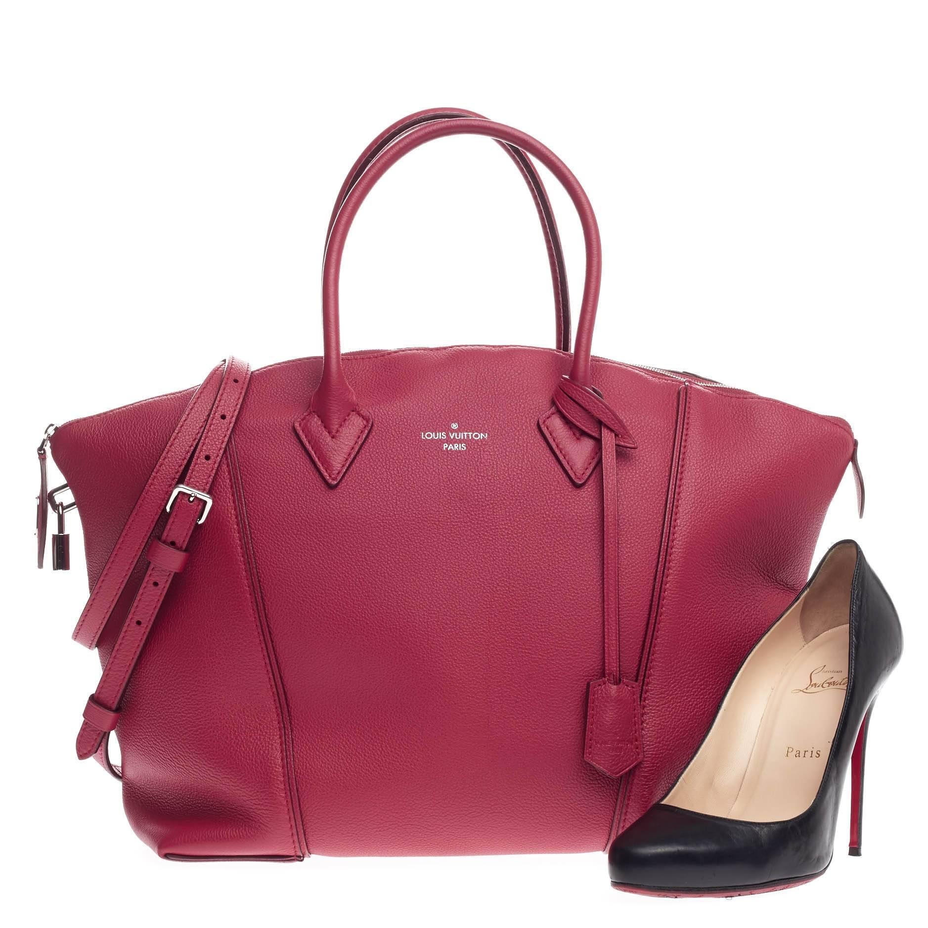 This authentic Louis Vuitton Soft Lockit Leather MM first introduced in 1958, is re-imagined with modern and understated, clean lines showcasing the brand's ever-evolving style. Crafted from raspberry leather, this chic tote features dual-rolled