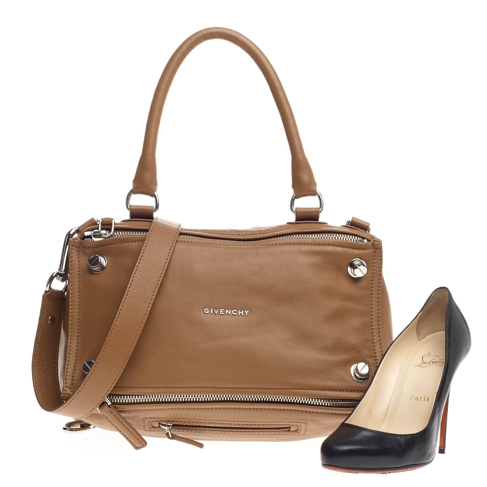 This authentic Givenchy Pandora Bag Bolt Stud Leather Medium is the perfect companion for any on-the-go fashionista. Crafted from brown leather, this edgy and cult-favorite satchel features a pandora box-inspired silhouette, a singular top handle,