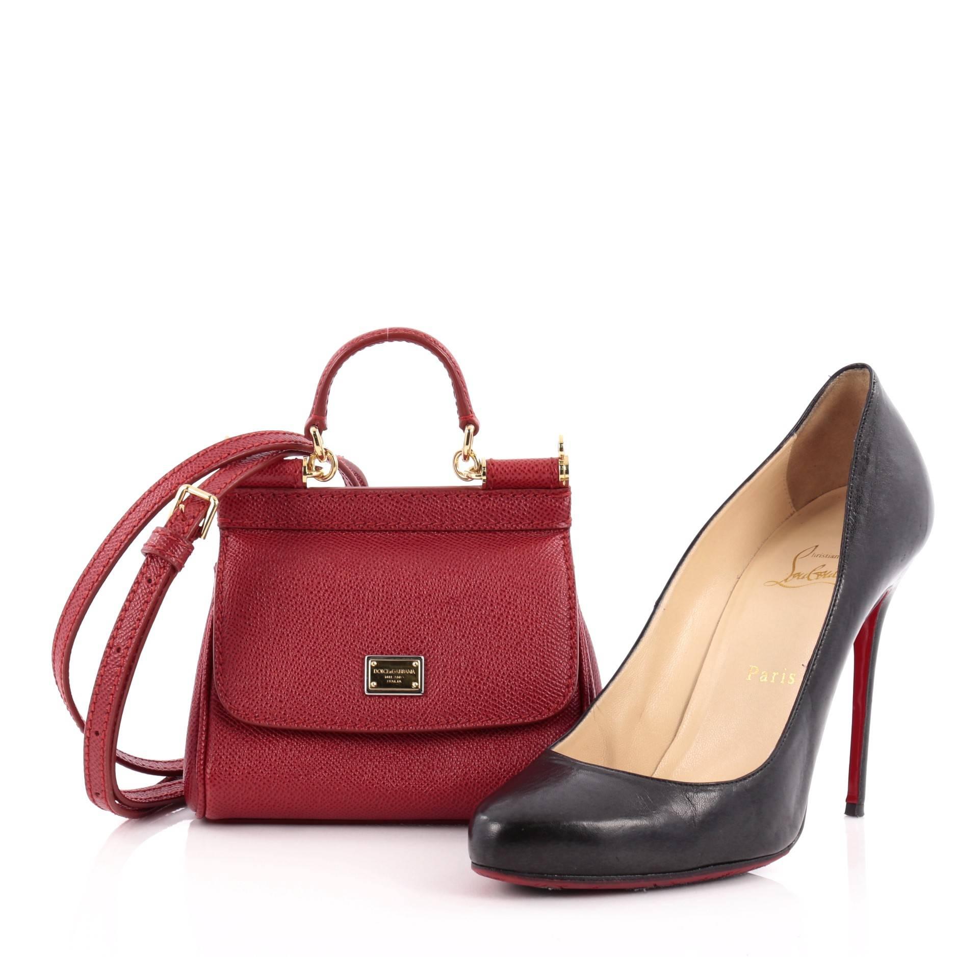 This authentic Dolce & Gabbana Miss Sicily Leather Micro pays homage to the designers' Sicilian heritage with a fresh twist. Crafted from rouge red textured leather, this miniature, petite bag features a short leather top handle, detachable shoulder