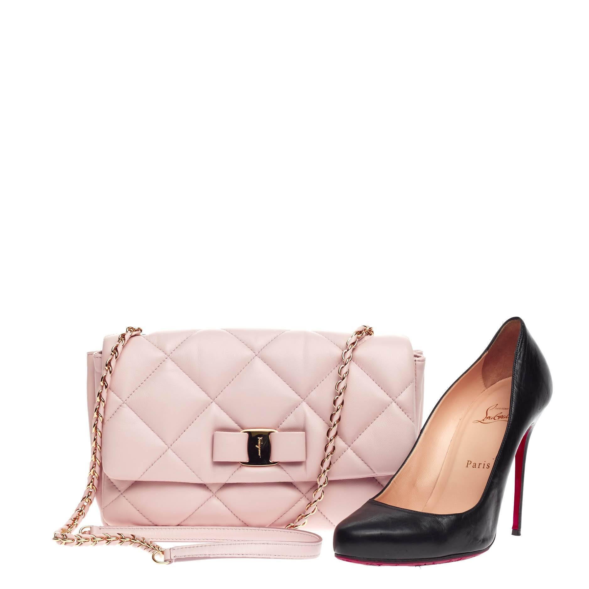 This authentic Salvatore Ferragamo Ginny Crossbody Quilted Leather Medium mixes a classic design with youthful, feminine flair. Crafted from baby pink quilted leather, this petite crossbody features the stylish Vara-shoe pleated bow design classic