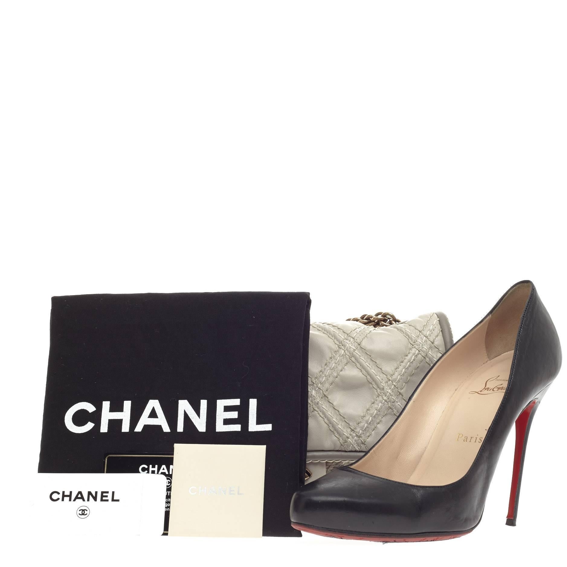 This authentic Chanel Triptych Flap Quilted Calfskin Small is sure to compliment just about every casual outfit. Crafted from light beige calfskin leather, this modern-style flap features triad diamond quilted stitching, Chanel reissue chain link