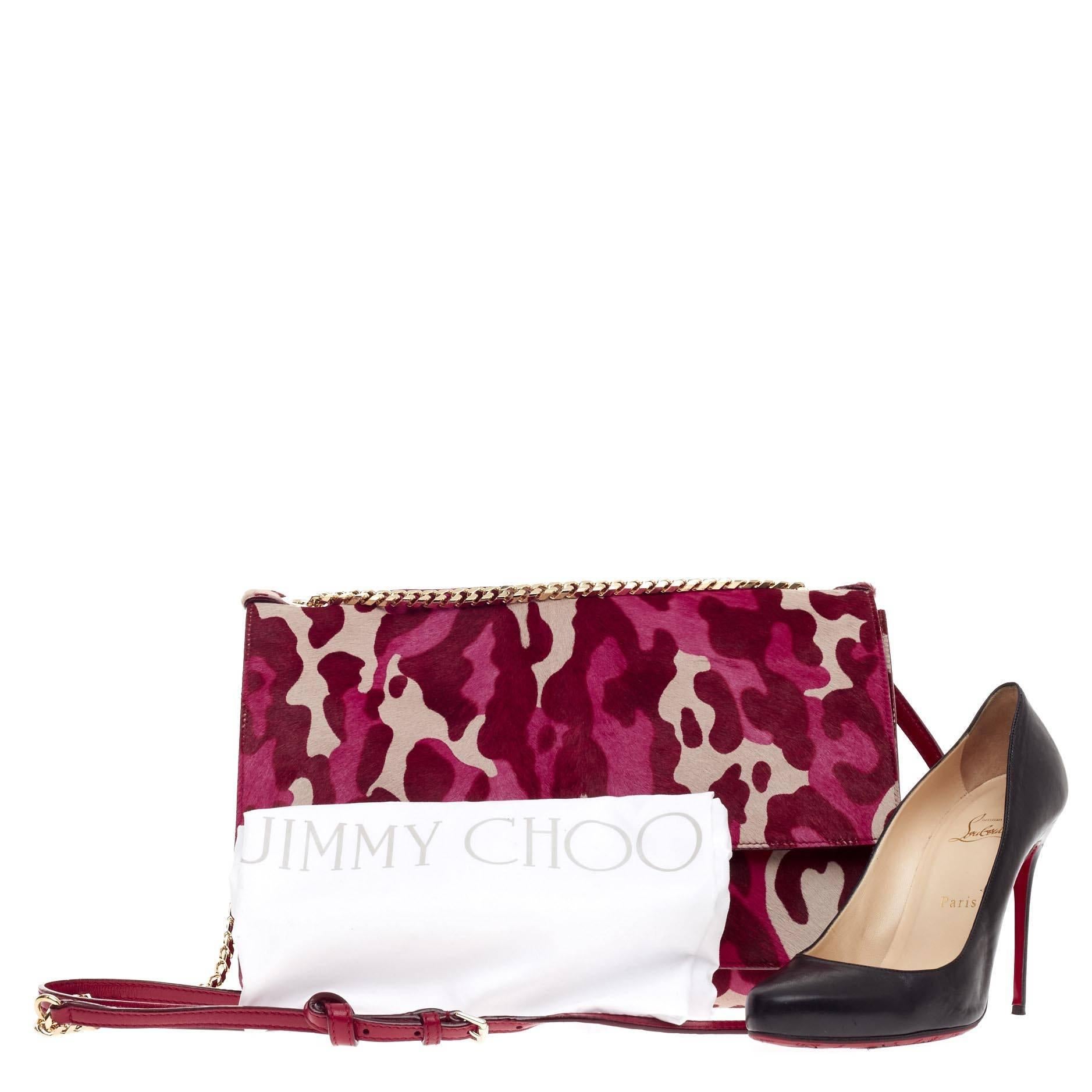 This authentic Jimmy Choo Rebel Soft Shoulder Bag Printed Pony Hair Medium is a luxurious, chic, and eye-catching accessory made for modern fashionistas. Crafted from beautiful pink camouflage printed pony hair, this shoulder bag features a chain