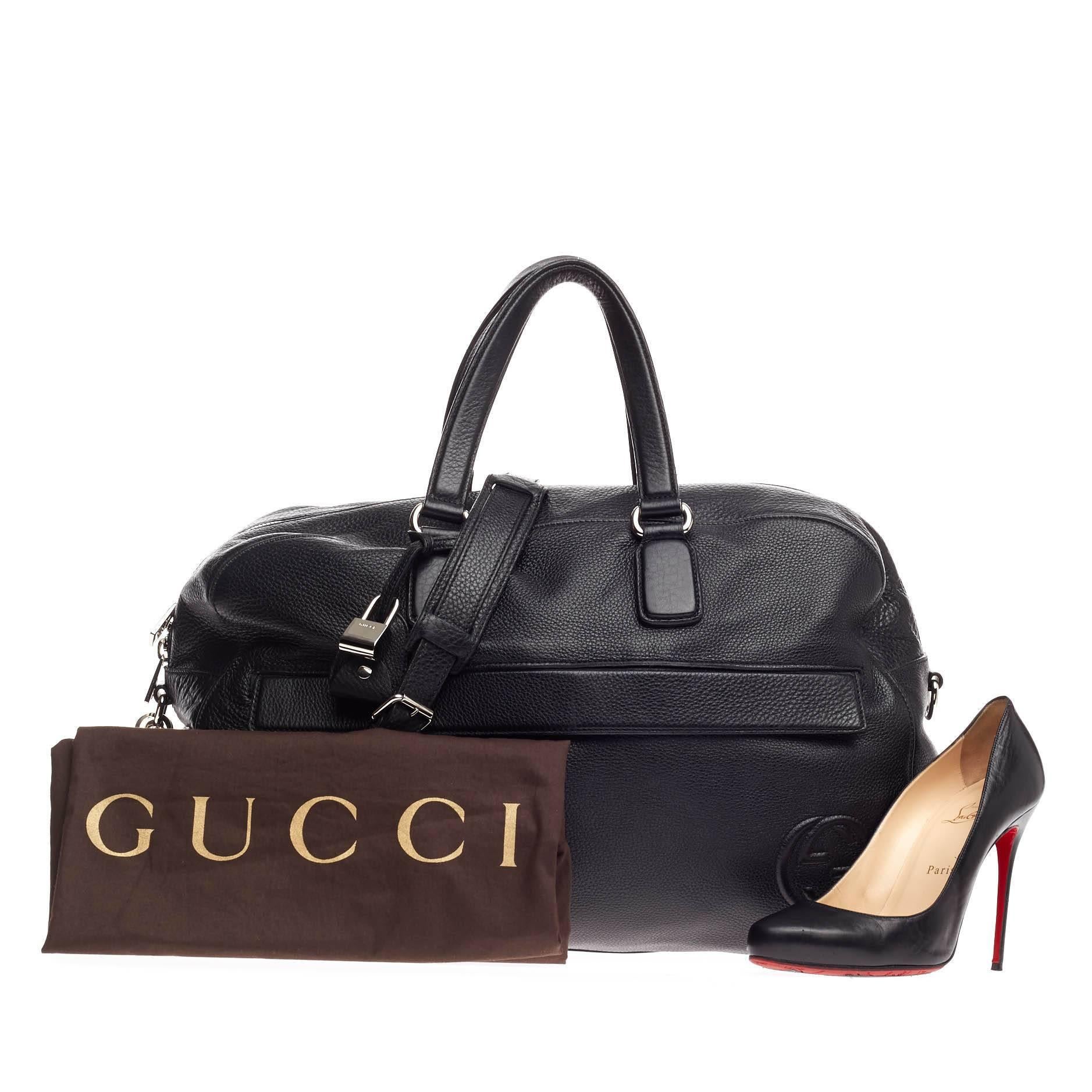 This authentic Gucci Soho Duffle Leather Large is a classic and sophisticated piece perfect for everyday excursions or light traveling. Crafted in black leather, this duffle bag features dual flat leather handles, front zip pocket, interlocking GG