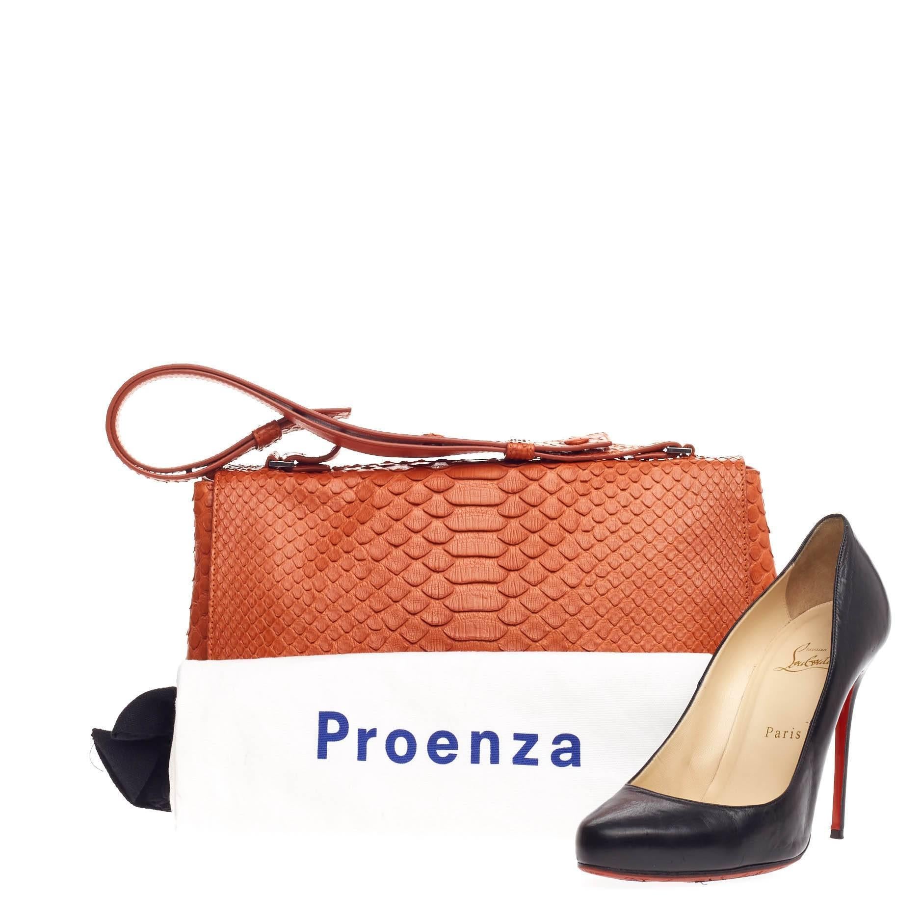 This authentic Proenza Schouler Courier Python Medium is a minimalistic stylish bag loved by fashionistas. Crafted from orange genuine python skin, this modern bag features adjustable snap-button shoulder strap, expandable snap sides, exterior back