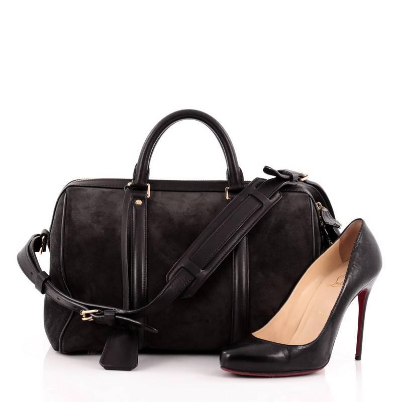 This authentic Louis Vuitton Sofia Coppola SC Bag Suede Calf Leather PM is as stylish and elegant as its designer. Crafted from asphalt dark gray suede with black leather trims, this simple yet refined duffle bag features sturdy rolled handles,