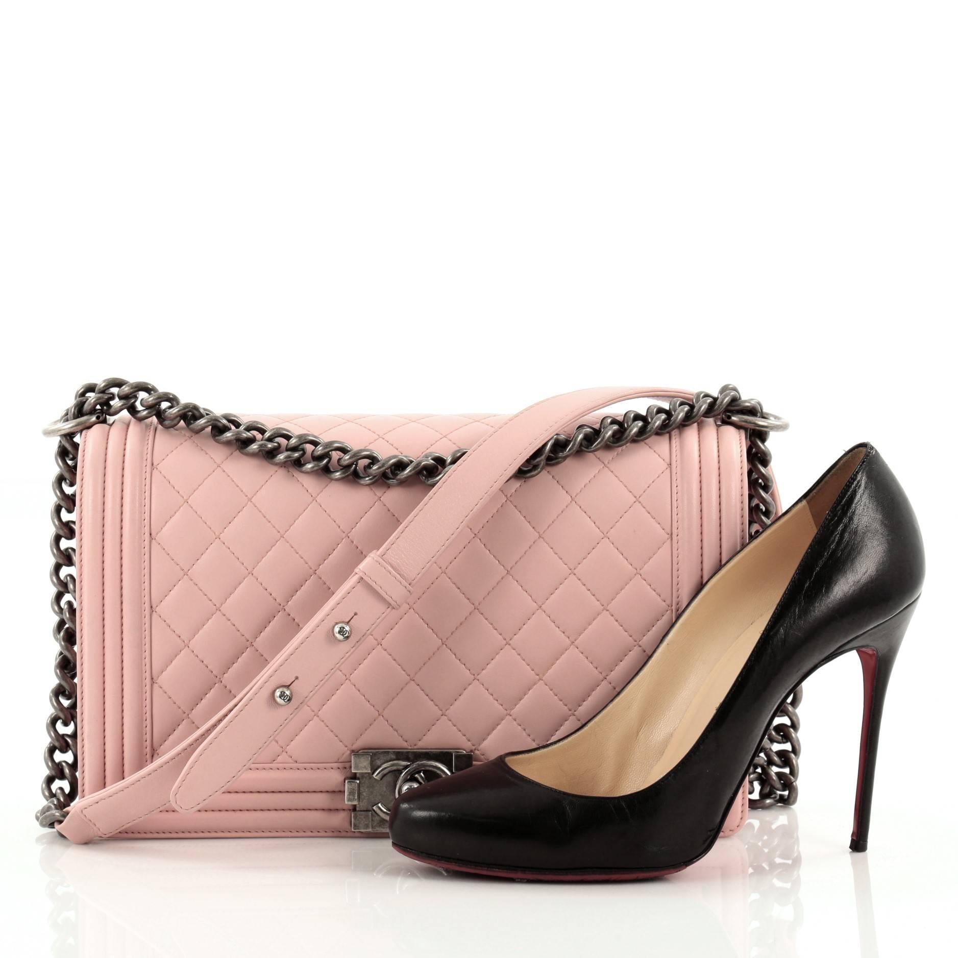 This authentic Chanel Boy Flap Quilted Lambskin New Medium is every woman's dream. Crafted from baby pink diamond quilted lambskin leather, this enviable Boy flap bag features a chunky chain link strap with shoulder pad, CC Boy logo push-lock