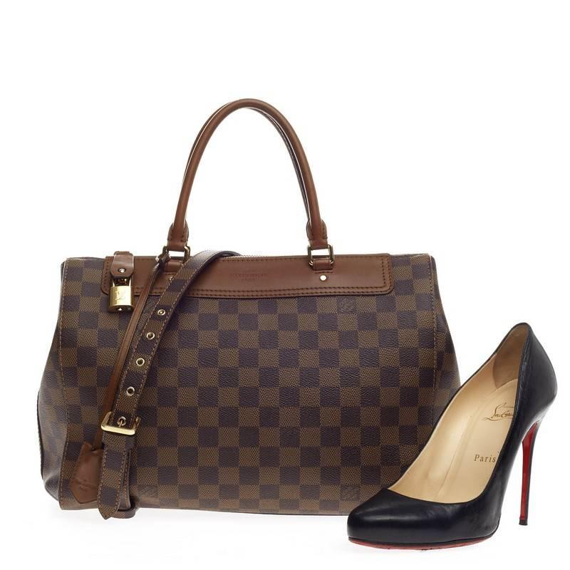 This authentic Louis Vuitton Greenwich Bag Damier combines luxurious style and functionality made for everyday excursions. Constructed with the brand's classic damier ebene coated canvas and brown nomade leather trims, this simple and structured