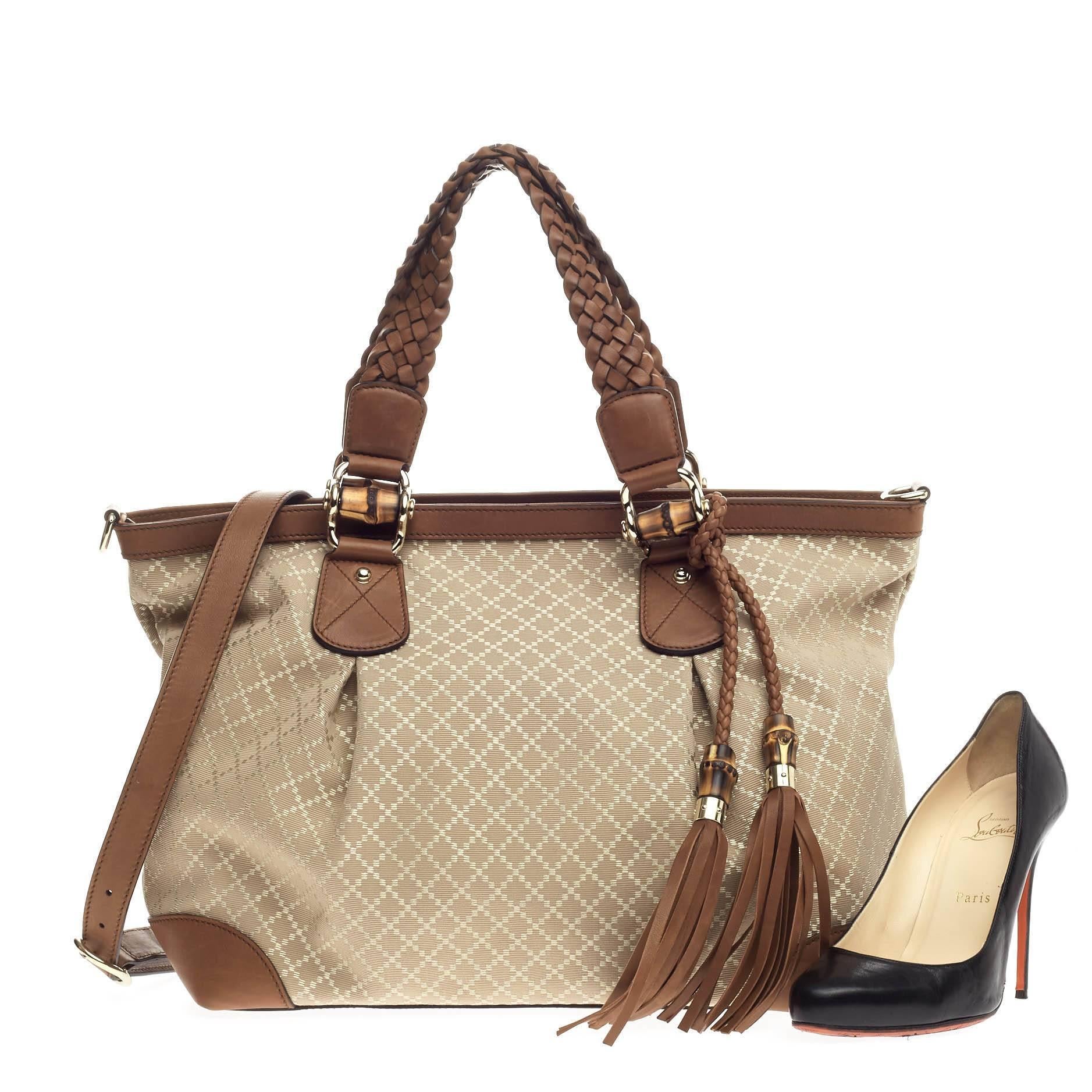 This authentic Gucci Eva Tote Diamante Canvas Large is modern and sophisticated in design. Crafted in beige diamante canvas with brown leather trims, this elegant tote features dual braided handles with bamboo and leather tassel details, protective