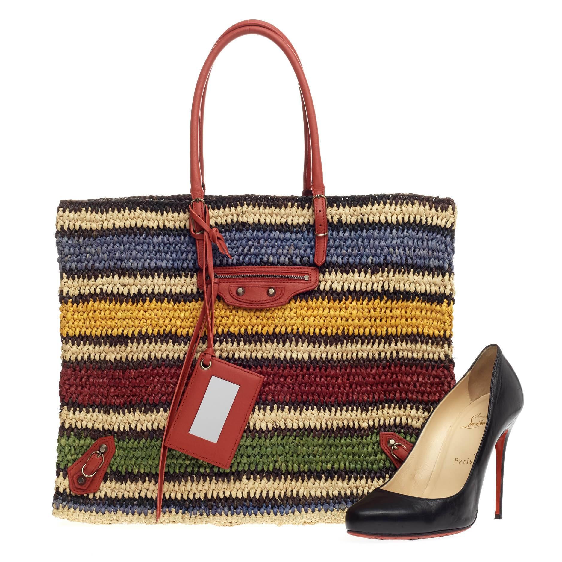 This authentic Balenciaga Papier A4 Woven Raffia is a casual, fun accessory perfect for everyday excursions or weekend travels. Crafted in multicolored woven raffia, this lightweight tote features slim handles, front zip pocket, iconic Balenciaga