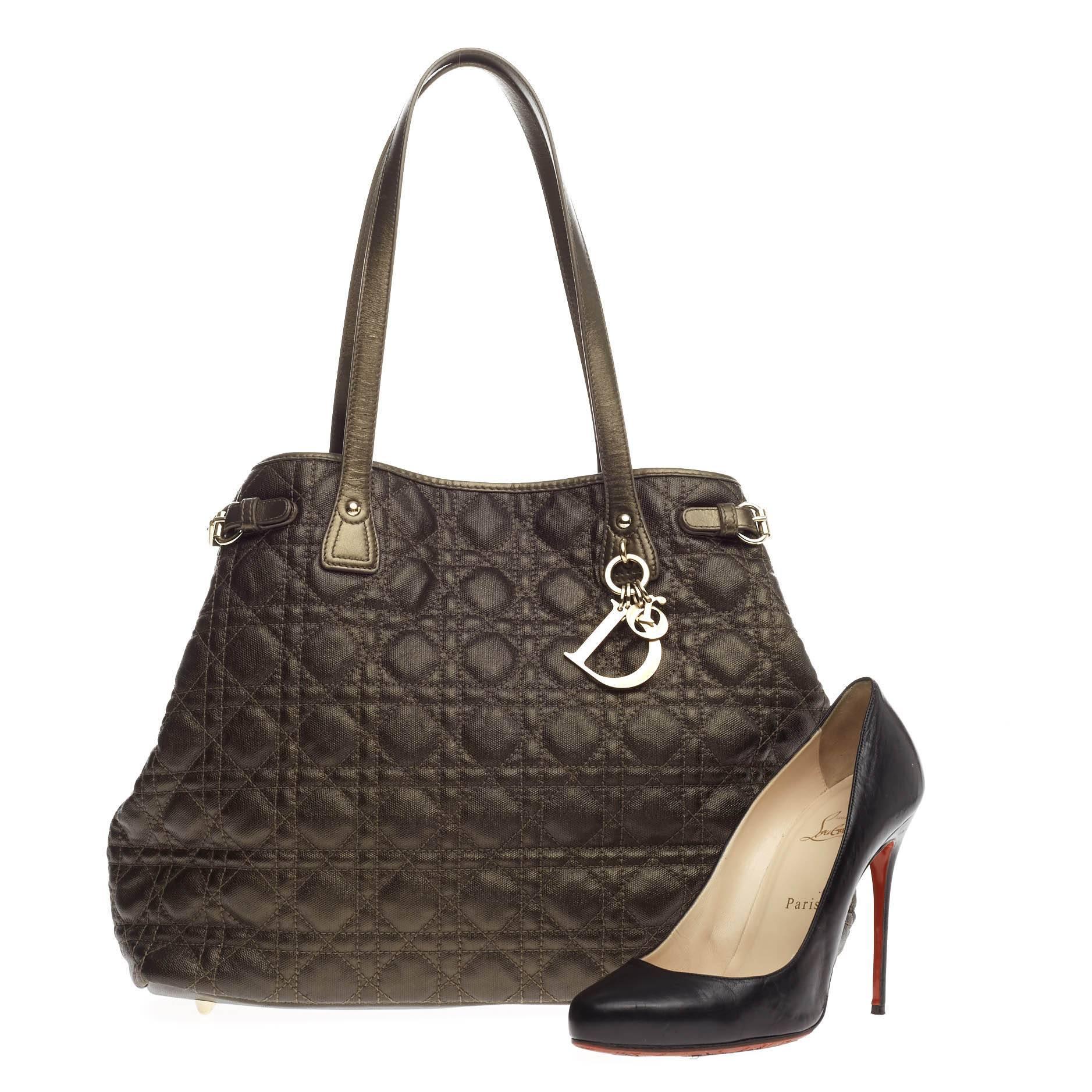 This authentic Christian Dior Panarea Tote Cannage Quilt Canvas Medium is a classic for every fashionista. Crafted in bronze quilted canvas, this chic tote features Dior's signature cannage quilting, slim dual-flat handles, gold charms, belt