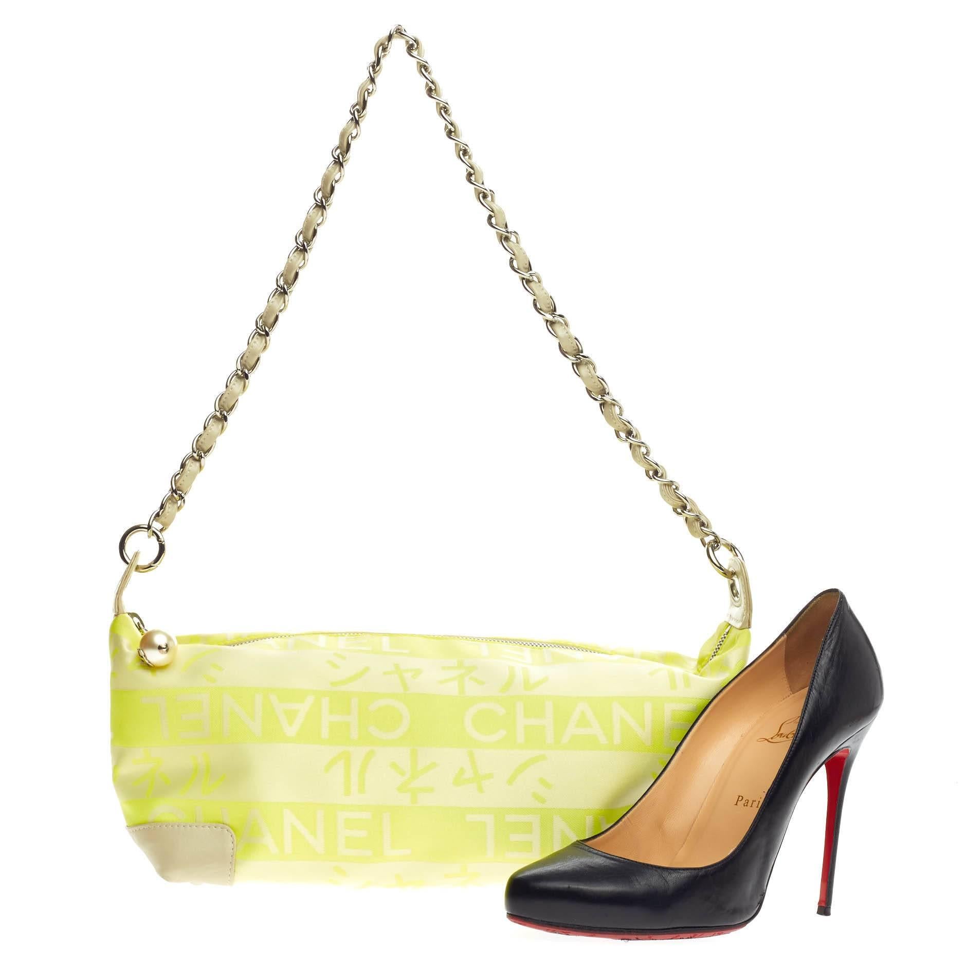 This authentic Chanel Pearl Charm Chain Shoulder Bag Printed Fabric Medium showcases a kitschy, casual design perfect for everyday use. Crafted from lime green fabric with beige leather trims, this shoulder bag features a stand-out Japanese