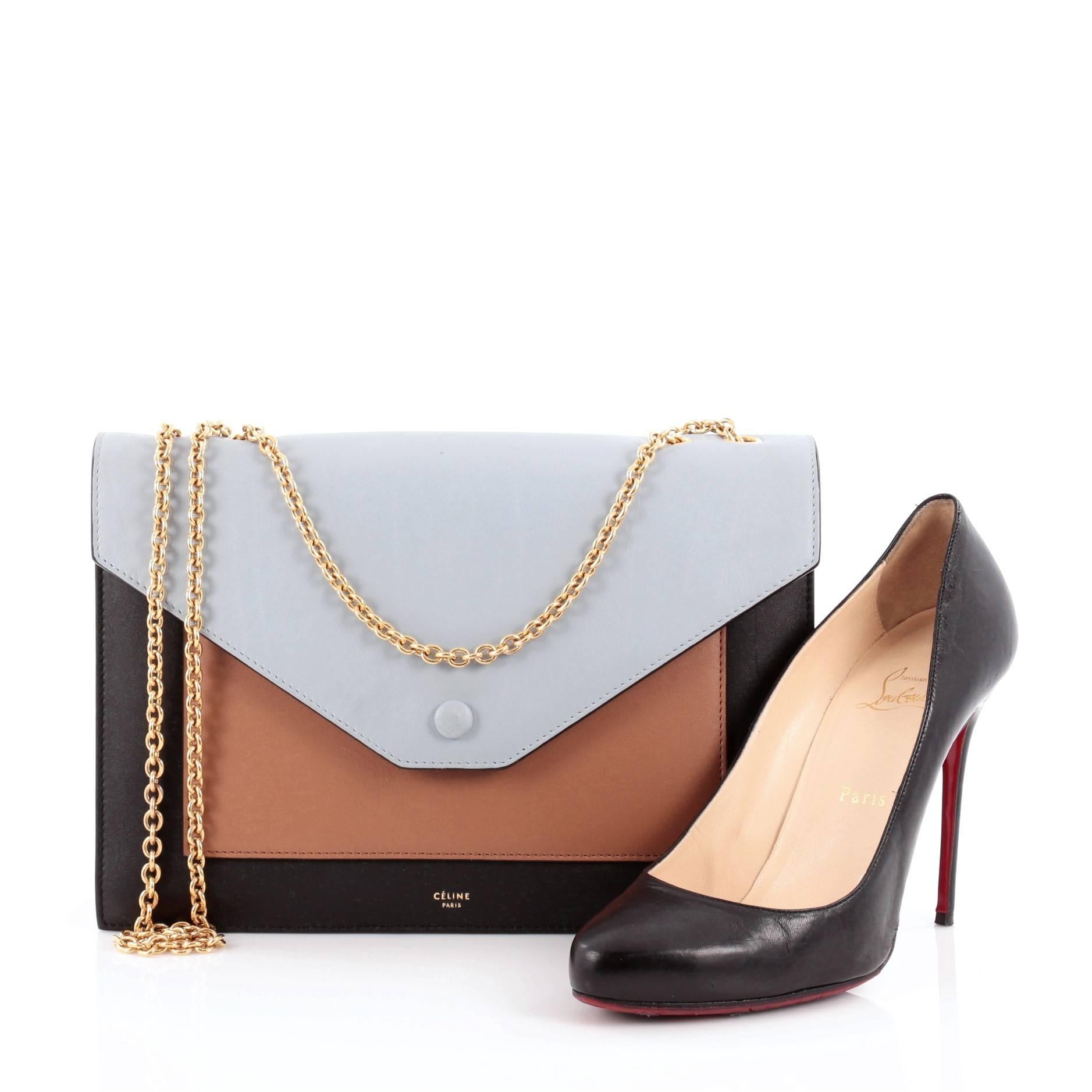 This authentic Celine Pocket Envelope Shoulder Bag Leather with Suede Medium presented in the brand's Pre-Fall 2014 Collection is a perfect minimalist bags for the modern woman. Crafted from tricolor sky blue, black, and brown leather, this bag