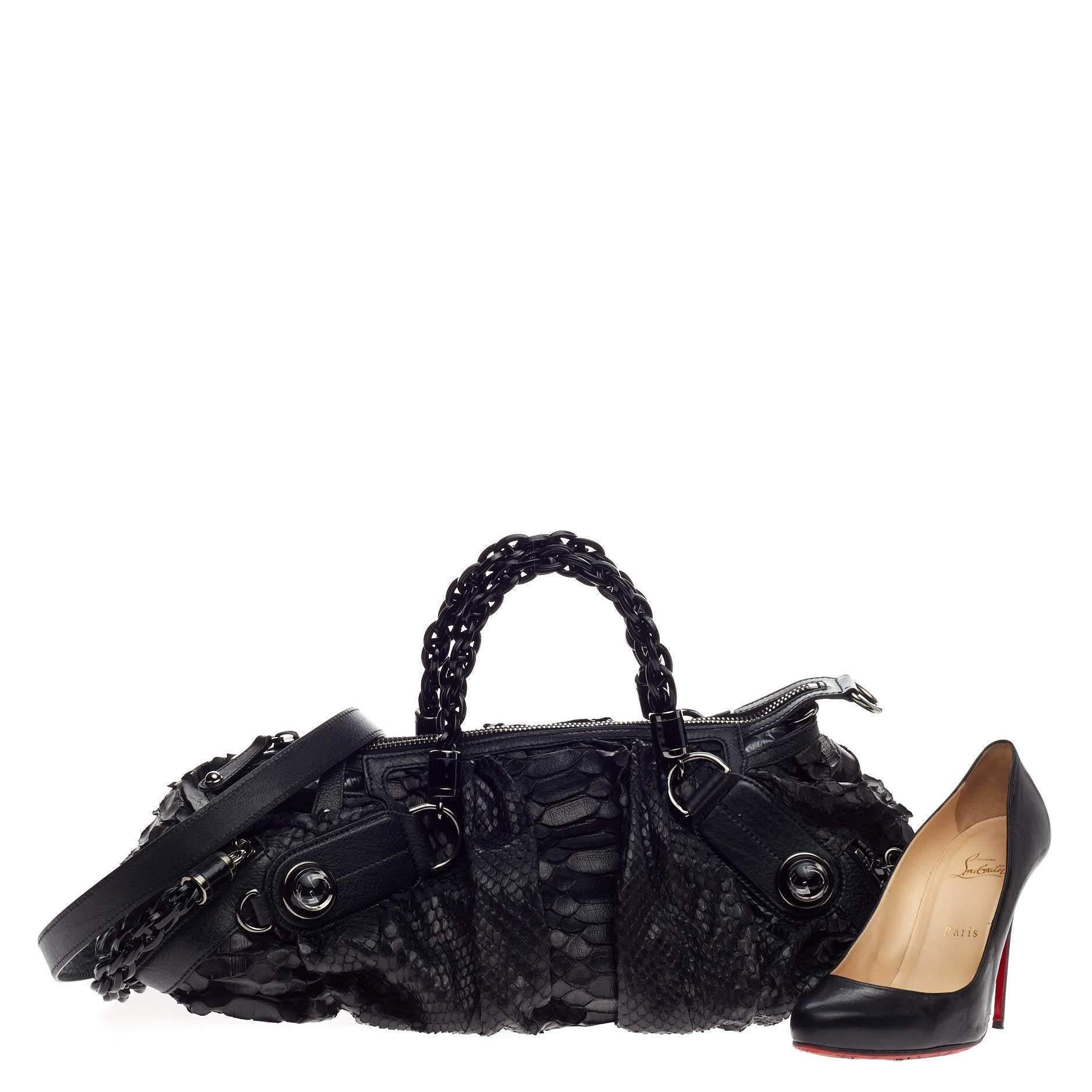 This authentic Gucci Galaxy Convertible Satchel Python Medium mixes the brand's classic and chic design with an edgy twist. Crafted in sleek black genuine python skin with black leather trims, this cool-girl satchel features a pleated silhouette,