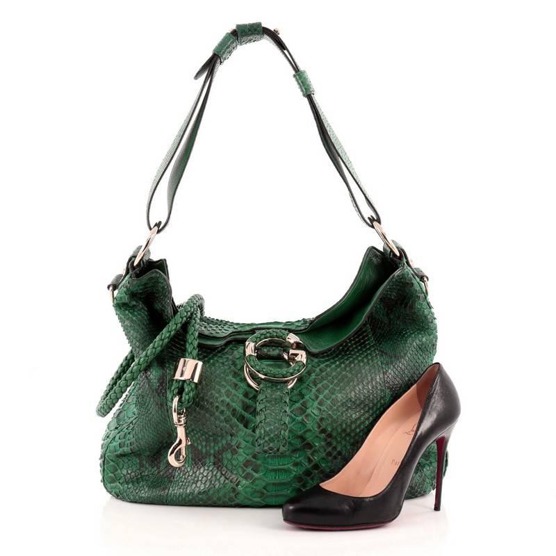 This authentic Gucci G Wave Hobo Python Medium is a marvelous shoulder bag for everyday use. Crafted from green genuine python skin, this super-chic shoulder bag features looping python shoulder strap, detachable woven leather strap, G ornament with