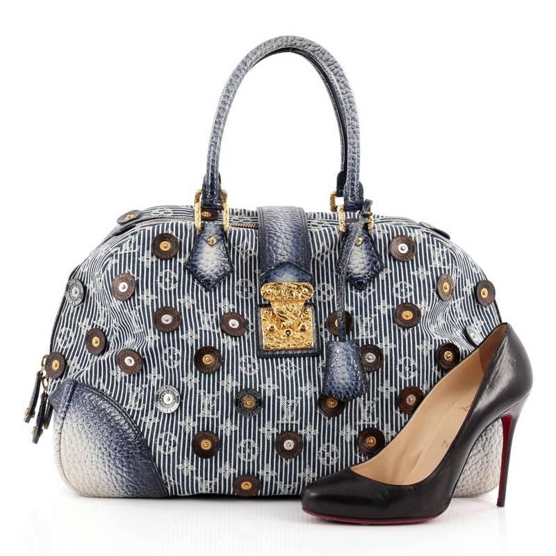 This authentic Louis Vuitton Polka Dot Bowly Denim presented in the brand's Spring/Summer 2007 Collection from designer Marc Jacobs is a hard-to-find collector's item made for LV lovers. Crafted from Louis Vuitton monogram striped blue denim, this