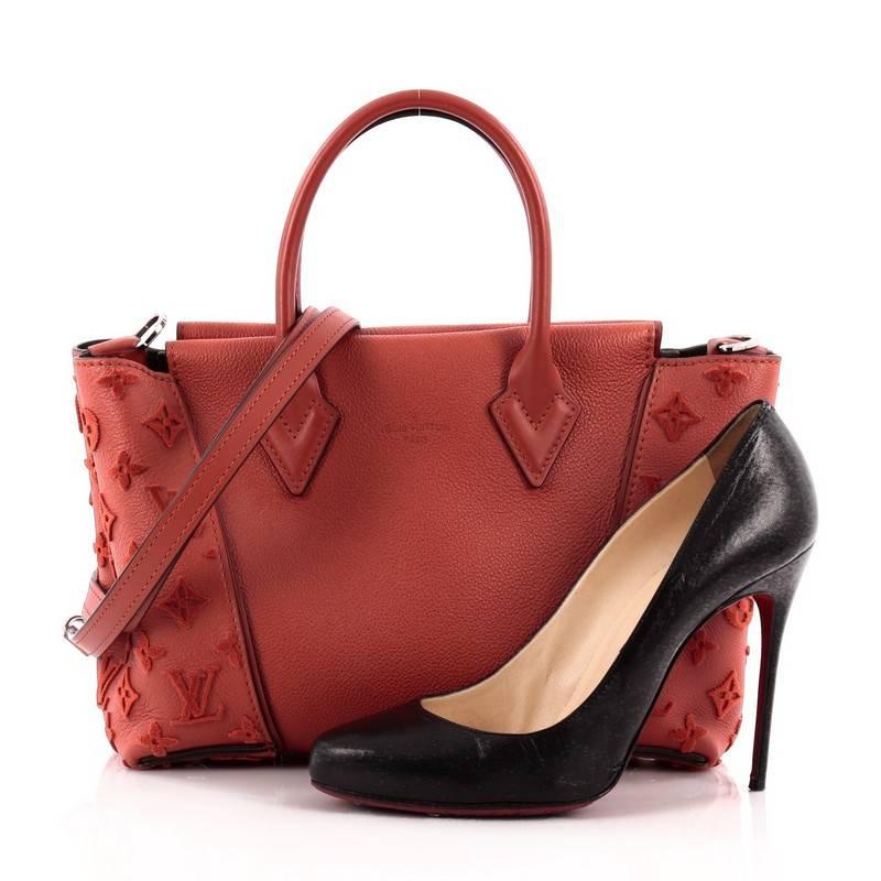 This authentic Louis Vuitton W Tote Veau Cachemire Calfskin BB is a collector’s dreams with a fresh and youthful design made for the modern woman. Crafted from red veau cachemire calfskin leather, this miniature tote features dual-rolled handles,
