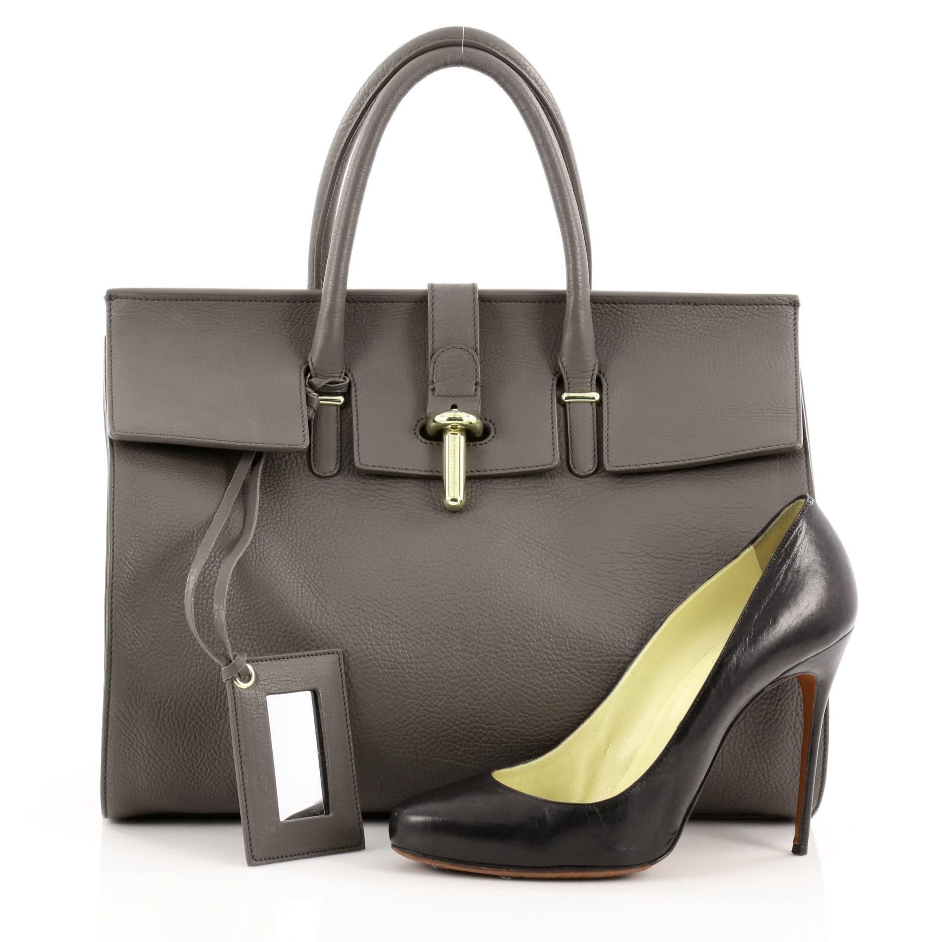 This authentic Balenciaga Tube Round M Tote Leather is an ideal, stylish accessory for everyday wear. Crafted from anthracite grey leather, this minimalist tote features dual-rolled leather top handles, removable hanging leather-frame hand mirror,