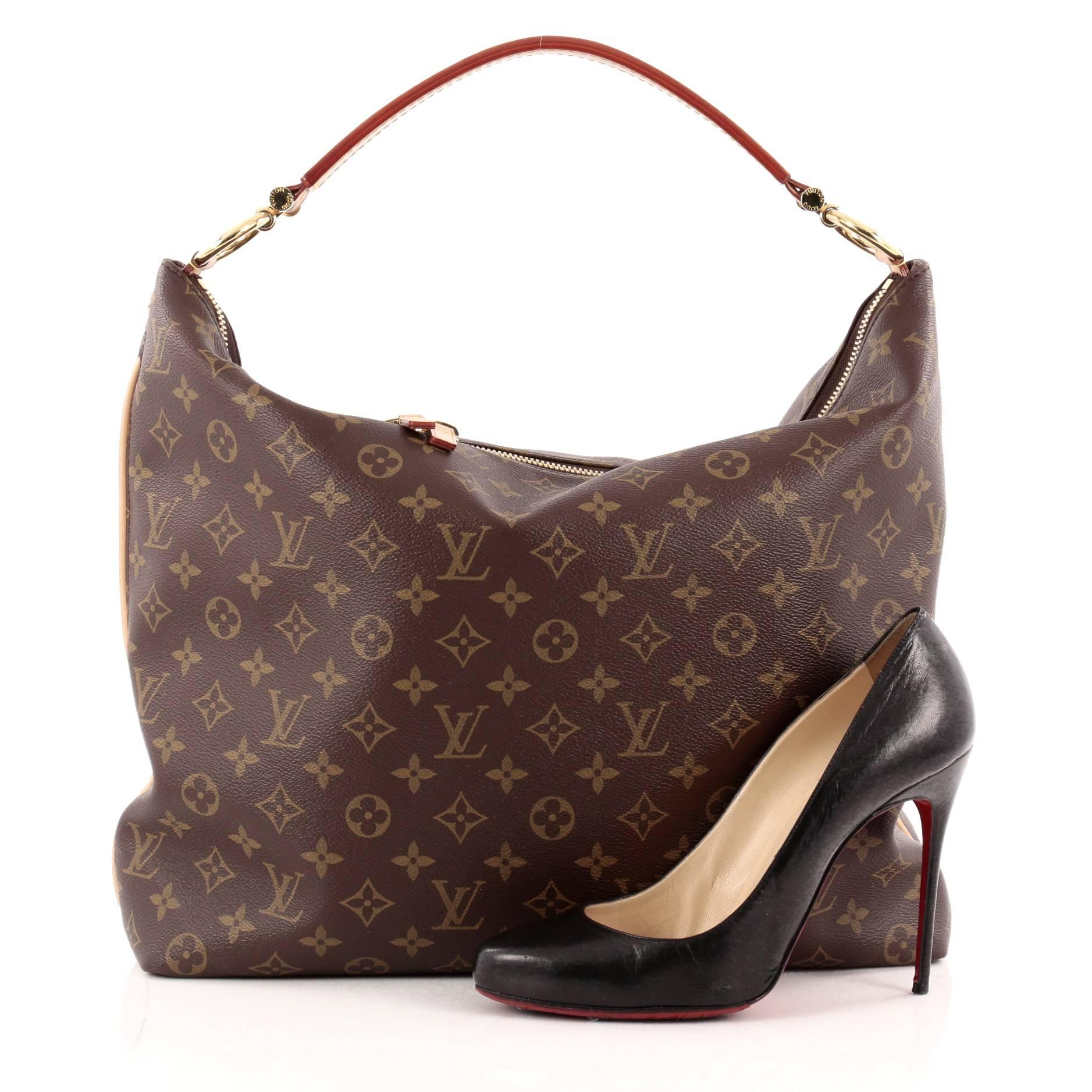 This authentic Louis Vuitton Sully Monogram Canvas MM mixes luxurious heritage style with a modern flair. Crafted in LV’s brown monogram coated canvas, this vintage-inspired hobo features a modern curved silhouette, thick vachetta cowhide looped