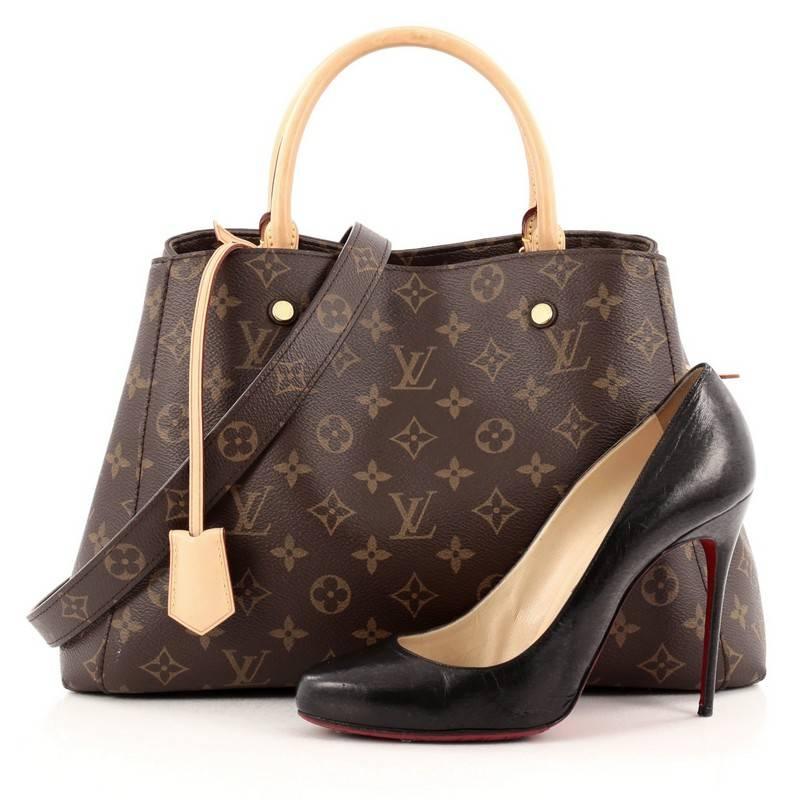 This authentic Louis Vuitton Montaigne Monogram Canvas MM named after the famed Parisian location is as sophisticated as it is sturdy. Crafted from the iconic Louis Vuitton's brown monogram coated canvas, this tote features dual-rolled vachetta