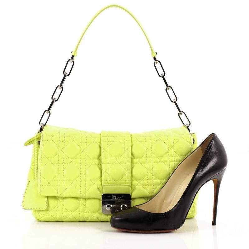 This authentic Christian Dior New Lock Flap Bag Cannage Quilt Leather Medium is a youthful, modern bag made for every fashionista. Crafted from striking neon yellow leather in Dior's famous cannage quilting, this bag features a silver chain link