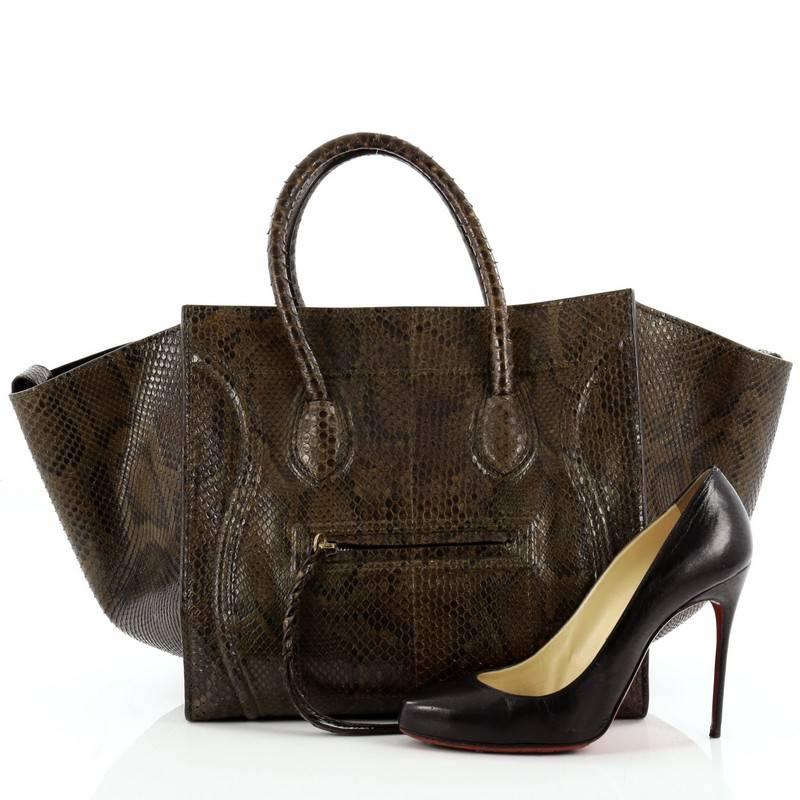 This authentic Celine Phantom Python Medium by Phoebe Philo mixes classic minimalist Celine style with stand-out, luxe detailing. Crafted from genuine dark brown with green python skin, this ultra-chic tote features exterior front zip pocket with