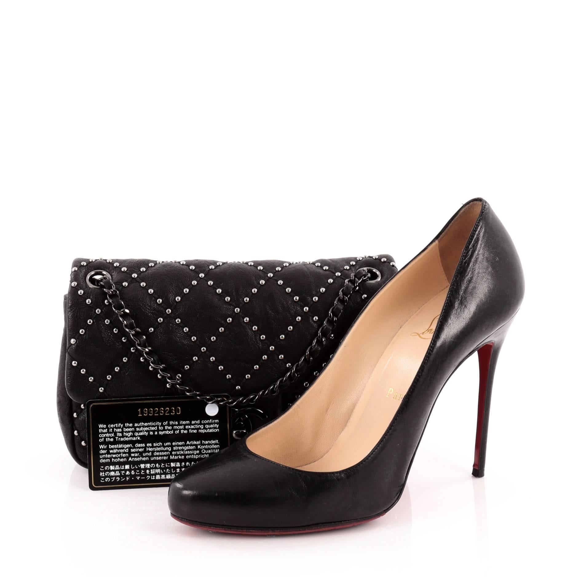 This authentic Chanel Paris-Dallas Flap Quilted Studded Distressed Calfskin Small presented in the brand's 2013 Metiers D'Art Collection exudes a classic style with luxurious edge made for the modern woman. Crafted from distressed black calfskin