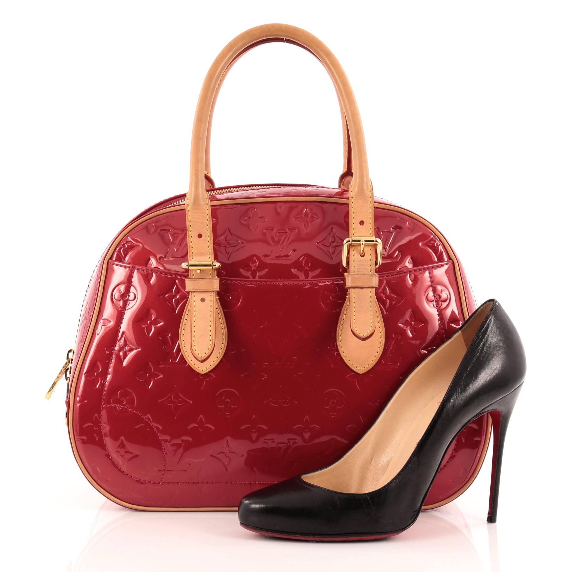 This authentic Louis Vuitton Summit Drive Monogram Vernis is perfect for on the go moments. Crafted in pomme d'amour red monogram vernis, this structured satchel features dual-rolled vachetta leather belted handles and trims, exterior pockets and