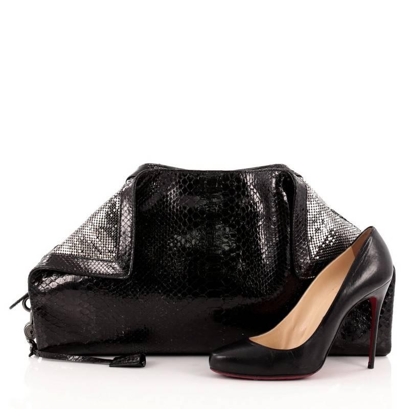 This authentic Salvatore Ferragamo Pitone Specchio Clutch Python is a spectacular and rare runway piece made for the modern woman. Crafted black patent genuine python skin, this oversized clutch features folded back sequin corners and top trims and