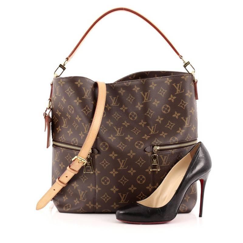This authentic Louis Vuitton Melie Handbag Monogram Canvas is a chic and classic city hobo perfect for everyday use. Crafted in brown monogram coated canvas, this north-south hobo features a single loop vachetta handle, two exterior side zip