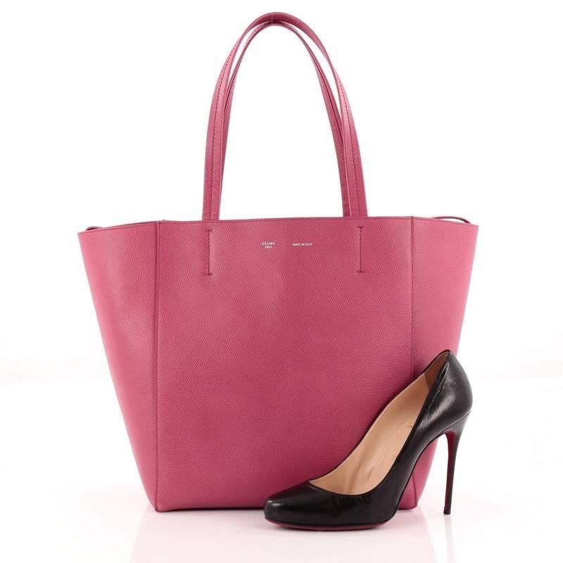 This authentic Celine Phantom Cabas Tote Leather Small is the perfect everyday shopper bag holding all essentials. Crafted in striking pink leather, this tote features dual slim leather handles, stamped Celine logo and extended side ties and