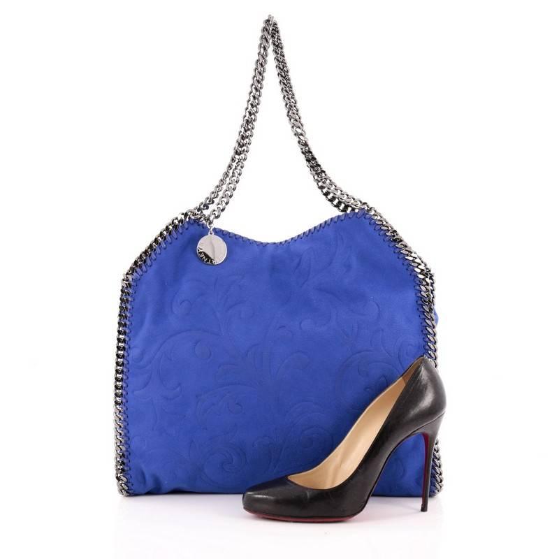 This authentic Stella McCartney Falabella Tote Embossed Faux Suede Small is a relaxed, modern bag made for on-the-go moments. Crafted from blue embossed faux suede, this no-fuss, easy tote features gunmetal chain link handles and trims, whipstitched