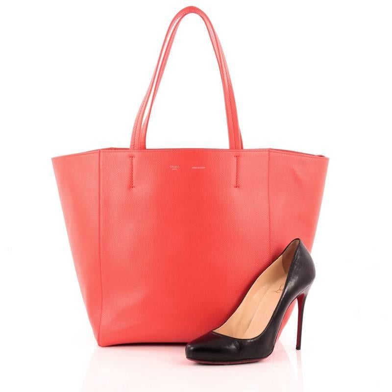 This authentic Celine Phantom Cabas Tote Leather Small is the perfect everyday shopper bag holding all essentials. Crafted in striking red leather, this tote features dual slim leather handles, stamped silver Celine logo and extended side ties and