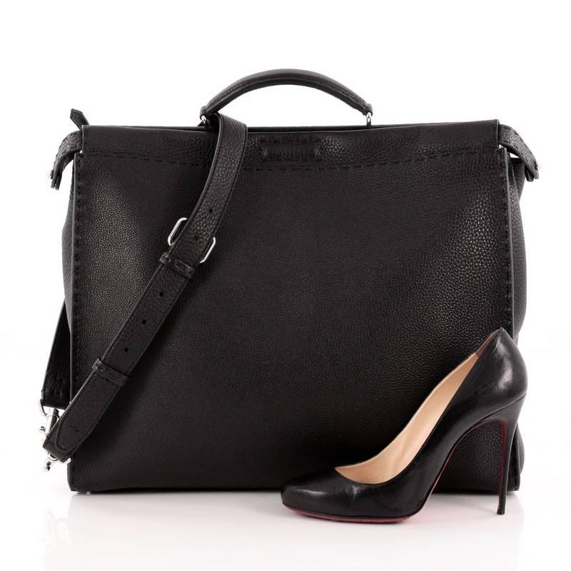 This authentic Fendi Selleria Peekaboo Monster Handbag Leather XL presented in the brand's Fall/Winter 2015 Collection is a stand-out, carry-all piece updating its classic Peekaboo style. Crafted from luxurious black selleria leather, this stylish