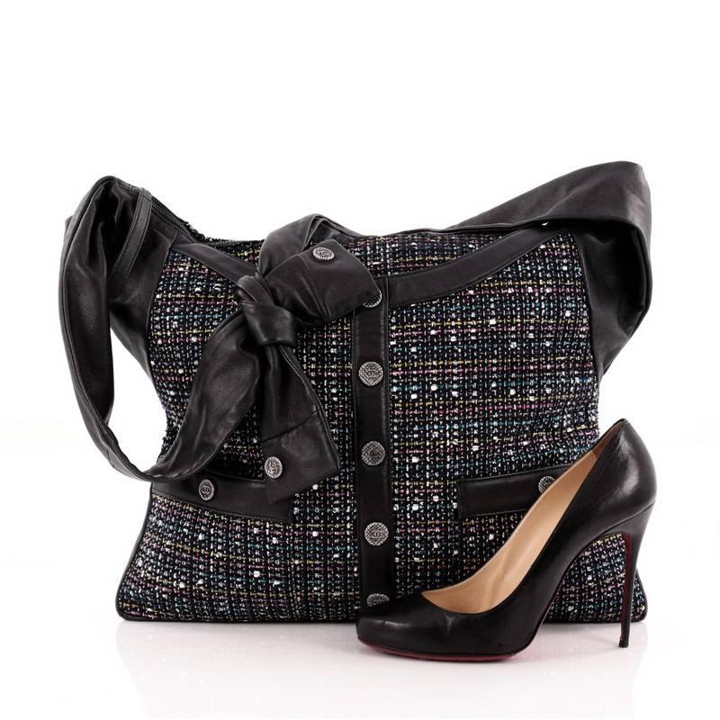 This authentic Chanel Girl Bag Tweed and Leather Medium inspired by Chanel’s iconic tweed jacket was first presented during the brand's Spring/Summer 2015 Runway Collection. Crafted from navy blue leather with plush multi-colored tweed design, this
