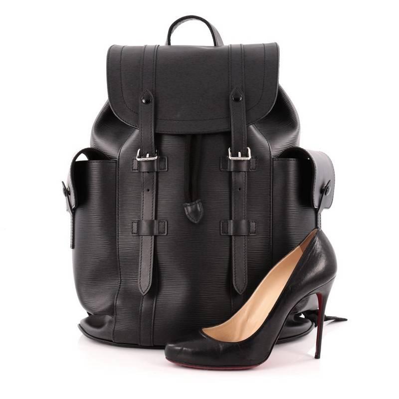 This authentic Louis Vuitton Christopher Backpack Epi Leather PM is a visually powerful everyday bag with the vigor of the outdoors. Crafted from noir black epi leather, this versatile bag features leather top handle, adjustable leather shoulder