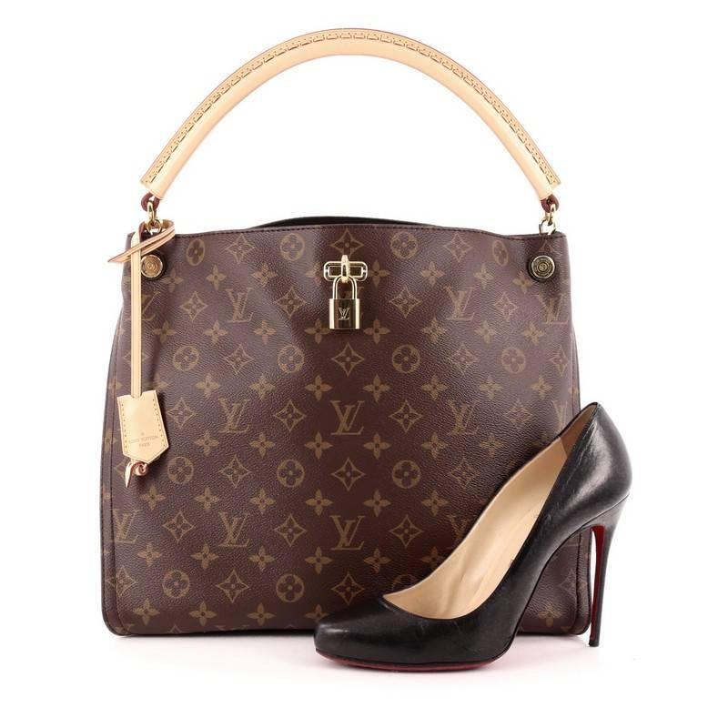 This authentic Louis Vuitton Gaia Handbag Monogram Canvas named after the Greek goddess, mixes elegant style with a feminine flair. Crafted from brown monogram coated canvas with black leather side gussets, this sophisticated bag features natural