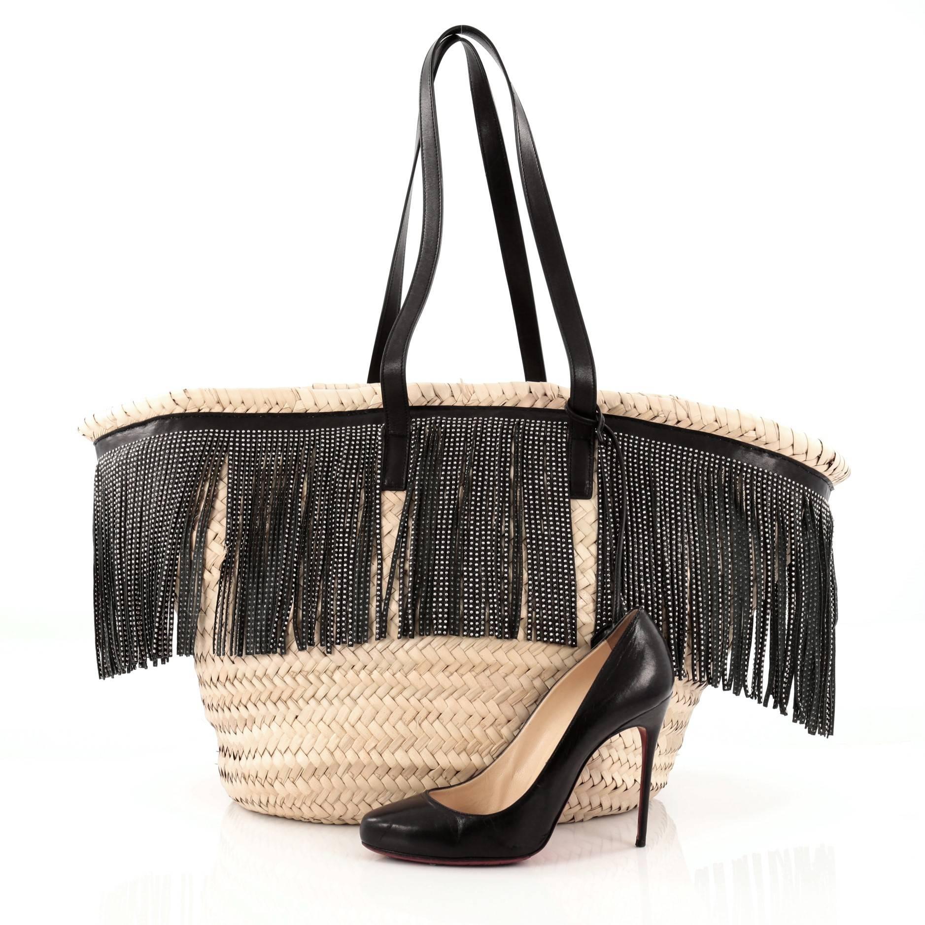 This authentic Saint Laurent Panier Basket Fringe Shopper Woven Raffia with Leather Large presented in the brand's 2015-2016 Collection is versatile enough for shopping in the city or taking to the beach. Crafted from woven raffia with black leather