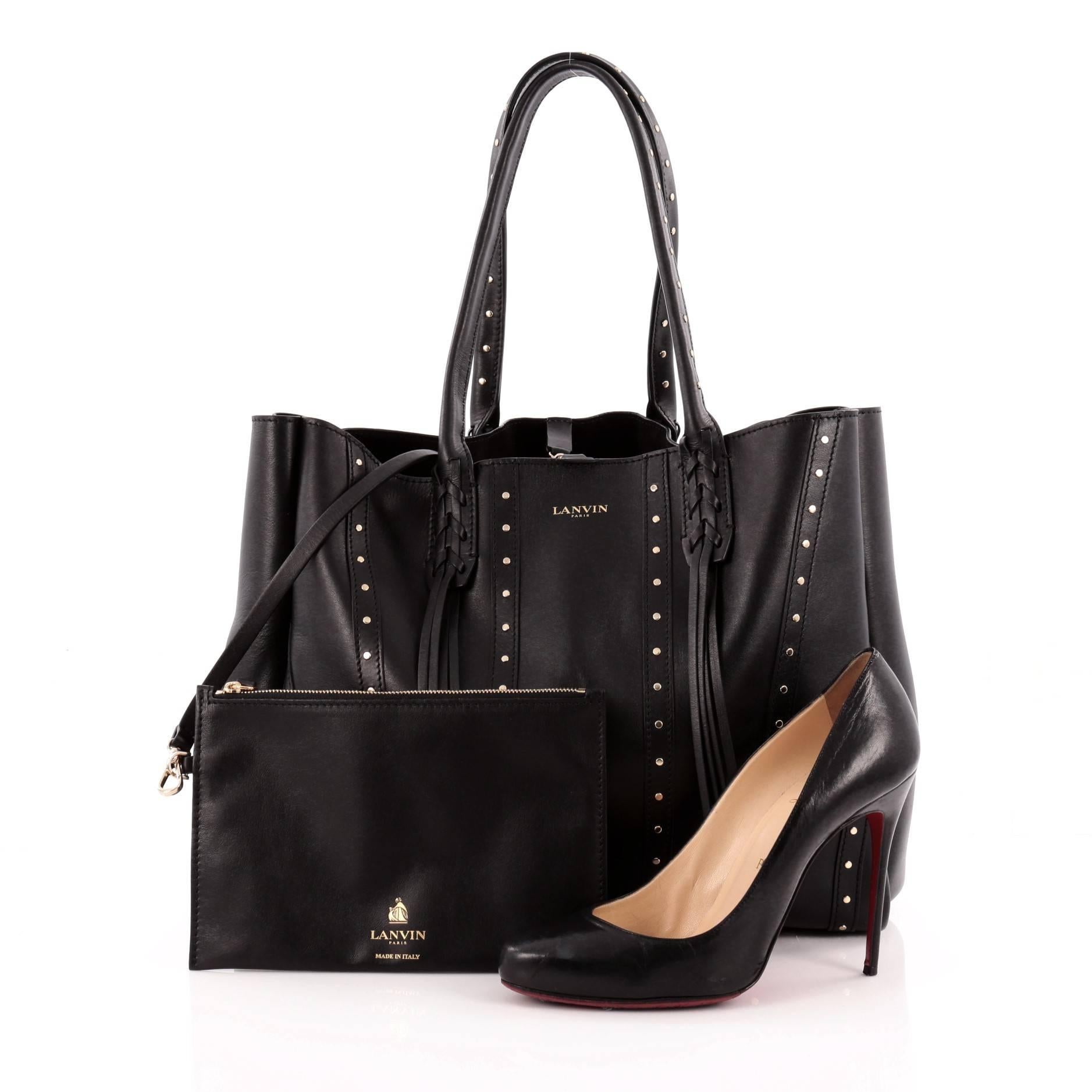 This authentic Lanvin Nela Shopper Tote Studded Leather Large released in the brand's 2014-2015 Collection is a sought-after tote perfect for your everyday use. Crafted from black leather with stud detailing, this chic tote features studded