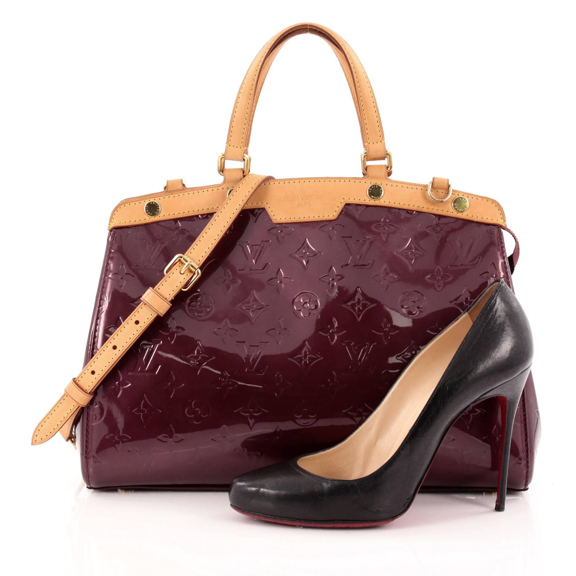 This authentic Louis Vuitton Brea Handbag Monogram Vernis MM is a staple for an everyday casual look. Crafted in rouge fauviste monogram vernis leather with cowhide leather trims, this structured yet feminine tote features dual flat handles,