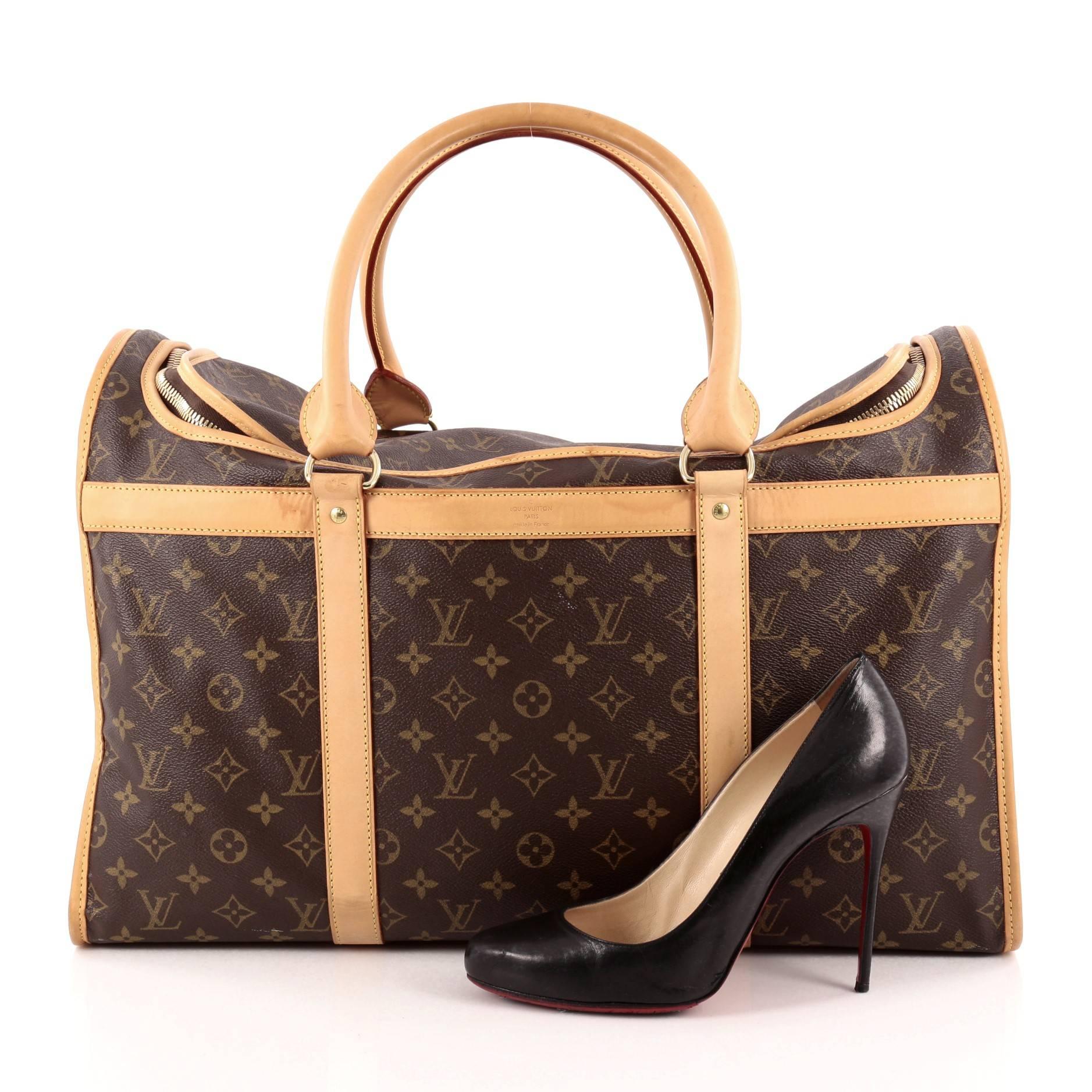 This authentic Louis Vuitton Dog Carrier Monogram Canvas 50 is the perfect stylish travel companion for your little one. Constructed in Louis Vuitton's iconic monogram coated canvas, this spacious dog carrier is equipped with gold-tone breathable