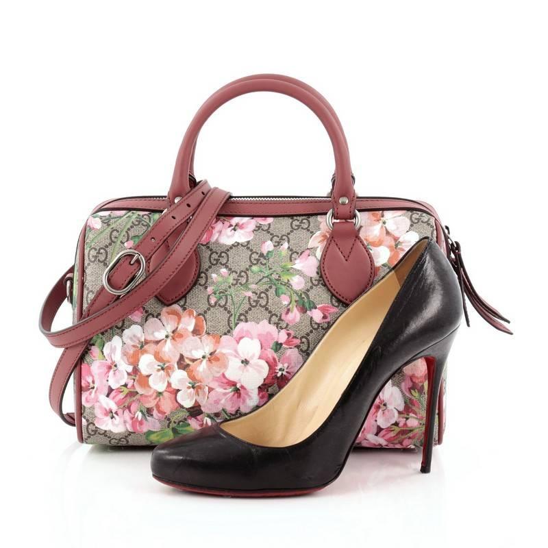 This authentic Gucci Convertible Boston Bag Blooms Print GG Coated Canvas Small created by famed designer Alessandro Michele updates its classic boston style with a fresh and youthful twist. Crafted in signature brown GG coated canvas with a blooms