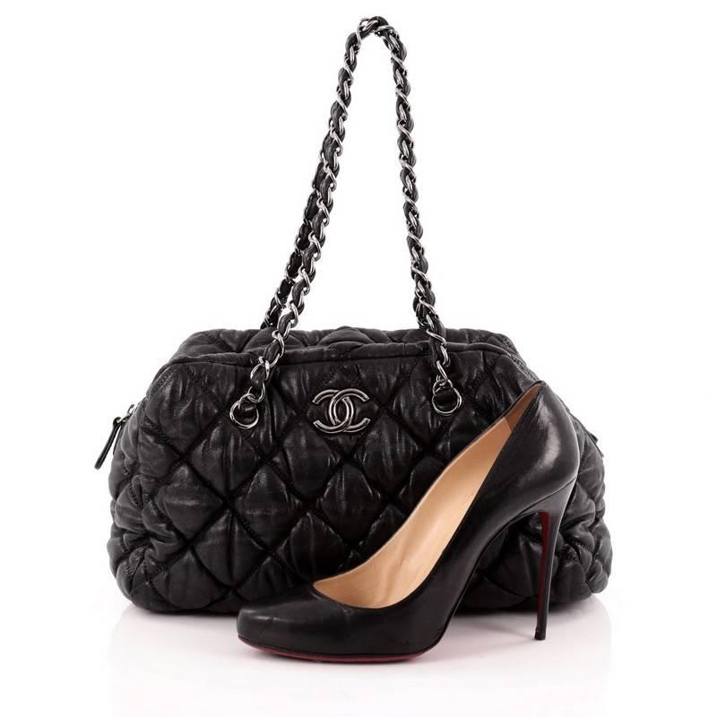 This authentic Chanel Bubble Bowler Bag Quilted Lambskin Medium showcases a very stylish twist on its classic bowler-design made for everyday use. Crafted from black quilted bubble lambskin, this chic bag features dual woven-in leather chain straps,