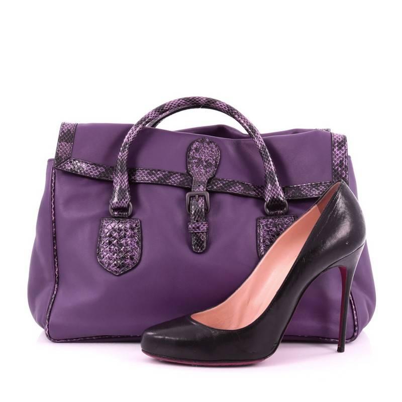 This authentic Bottega Veneta Double Sided Buckle Top Handle Bag Leather with Python Detail Large is a luxurious bag perfect for a weekend getaway. Crafted in purple leather, this bag features genuine purple python handles and edges and matte