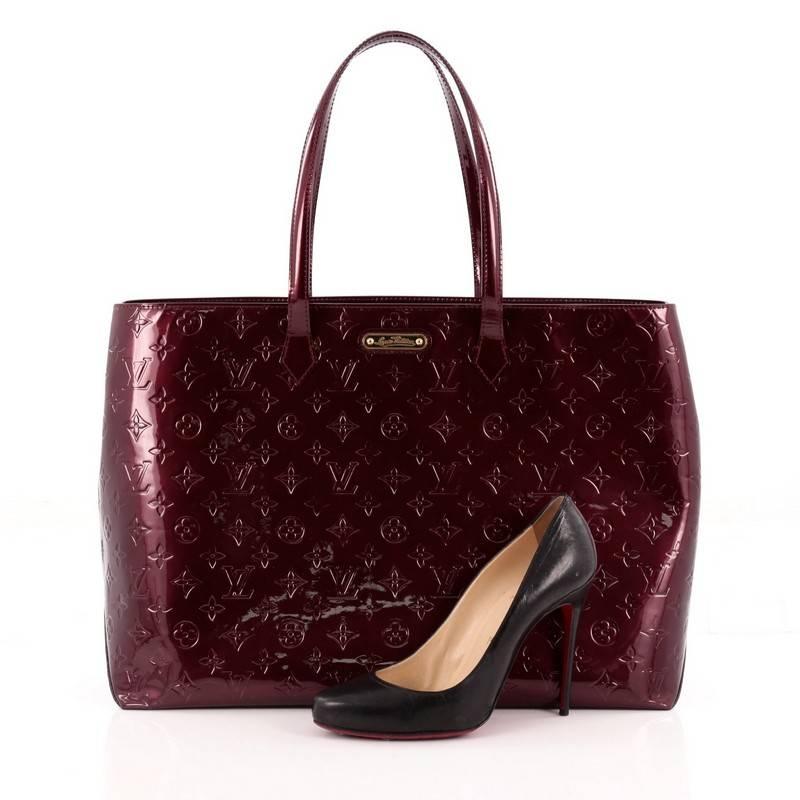 This authentic Louis Vuitton Wilshire Handbag Monogram Vernis GM combines elegance with sophistication ideal for day to day excursions. Crafted in rouge fauviste monogram vernis leather, this simple shopper tote features dual-flat handles, a sturdy