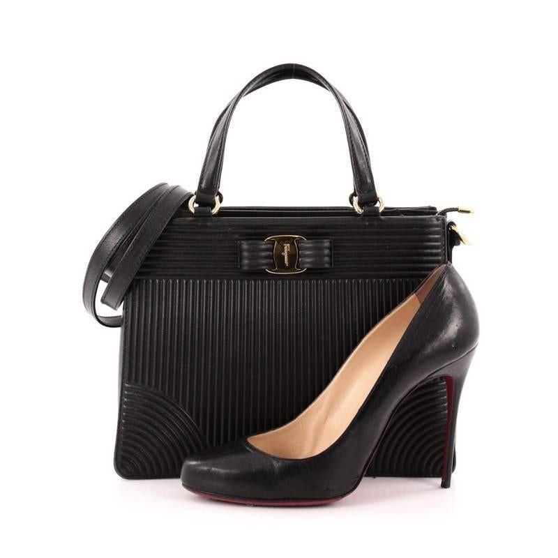 This authentic Salvatore Ferragamo Tracy Handbag Quilted Leather is a beautiful, chic tote made for everyday use. Crafted from black quilted leather, this feminine yet classic accessory features dual-flat top handles, detachable, adjustable shoulder