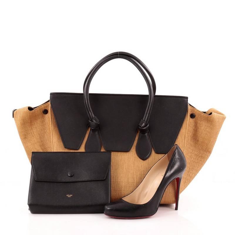 This authentic Celine Tie Tote Raffia and Leather Small is an absolute must-have for serious fashionistas. Crafted from brown raffia, this boxy, chic tote features dual-rolled leather handles with signature knot accents, expandable wings, a top flap