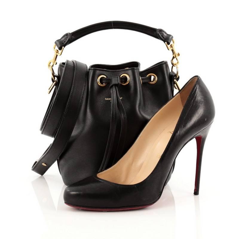 This authentic Saint Laurent Emmanuelle Bucket Bag Leather Small showcases a playful and fun style made for on-the-go moments. Crafted in black leather, this petite bucket bag features a detachable looped handle, adjustable leather strap, side zip