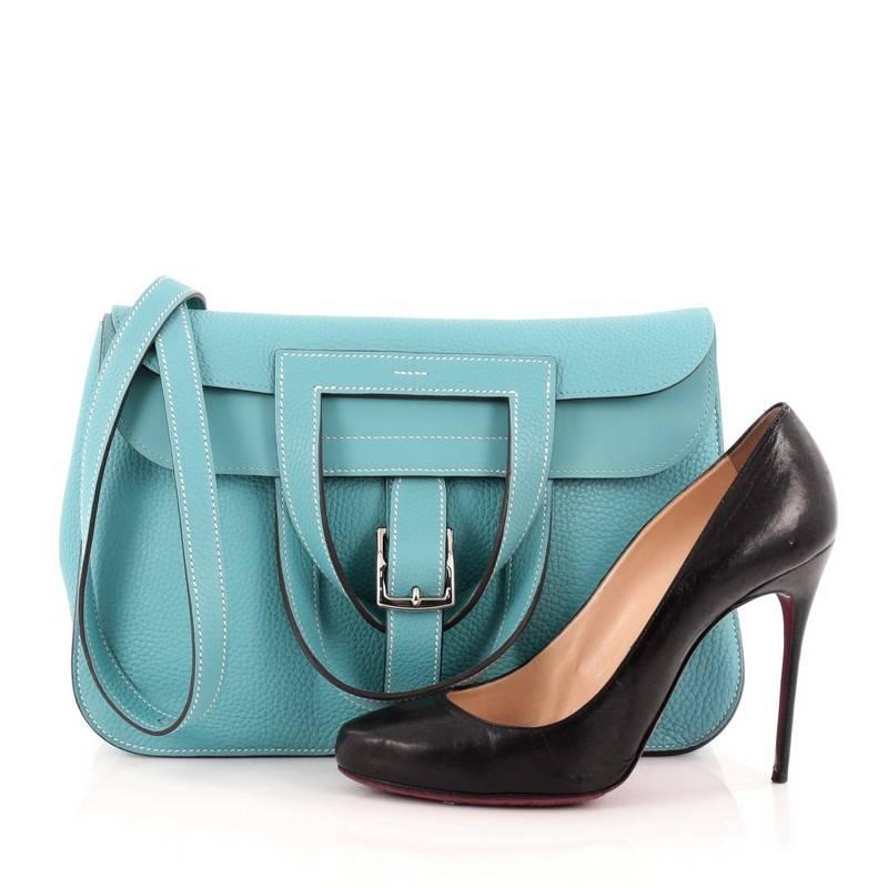 This authentic Hermes Halzan Handbag Clemence 31 presented in the brand's Fall/Winter 2014 Collection is a luxe, everyday accessory with an inventive, one of a kind style. Crafted from blue jean clemence leather, this stylish bag features an
